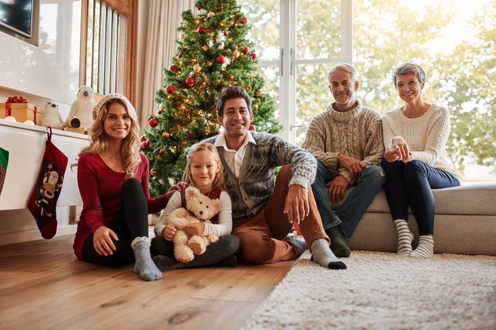 Multi generation family in front of christmas tree