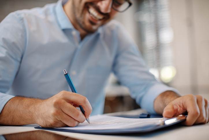 Young businessman signing a contract