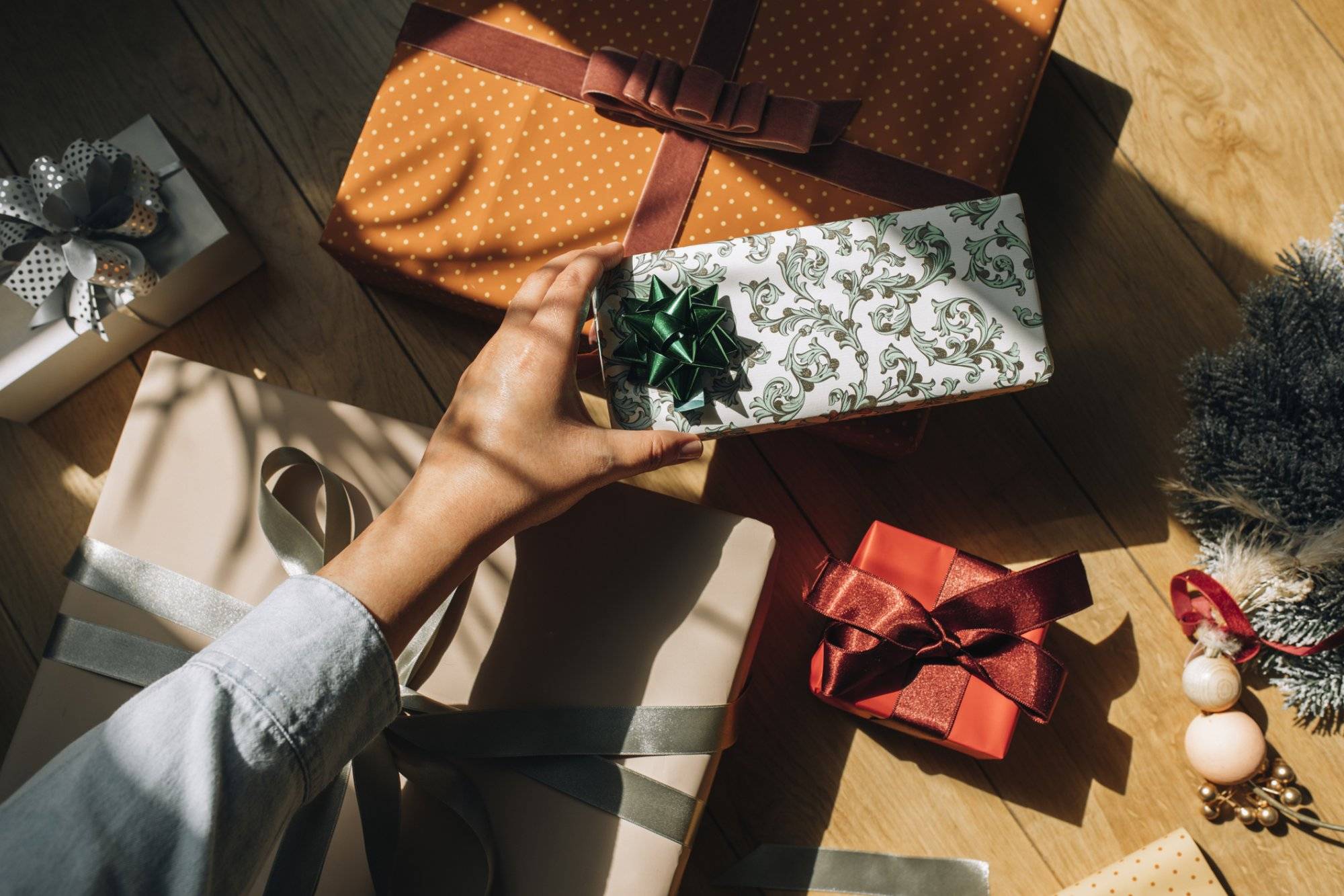 Hand of an anonymous woman holding a Christmas present, a close up.